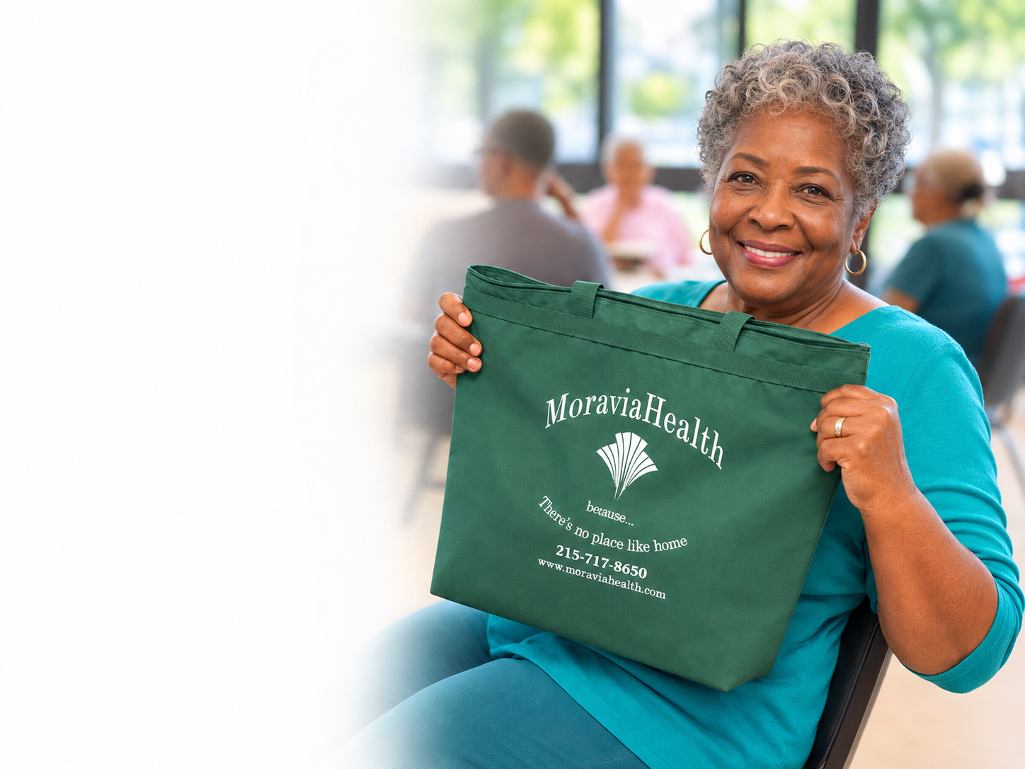 Woman smiling and holding a Moravia Health tote bag